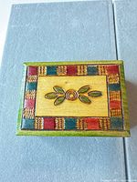 top view showing painted floral motif and multicolor border