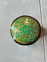 top view of trinket box showing hand-painted floral motif