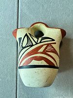 Front view showing geometric decoration and overall form