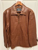 Front view of Joseph Barry brown leather jacket on hanger showing collar, zipper and pockets