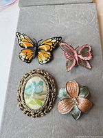 four brooches arranged together