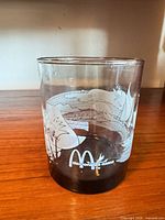 Front view showing McDonald’s arches, Hawaii text, sailboat scene, dark base