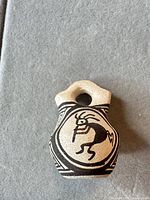 front view of miniature jar showing Kokopelli motif and overall form
