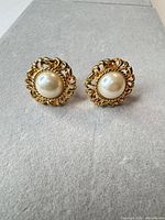 Front view showing gold-tone filigree and faux pearl