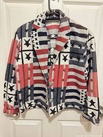 Full view of blazer hanging to show overall design, color and style