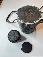 Lens, caps and worn hard case overview