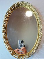 Front view of oval gilt metal mirrored tray