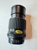 Full view of lens showing body, focus grip, aperture ring, JCII sticker