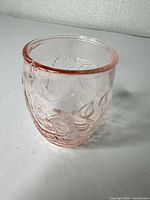 Front angled view showing pink pressed glass tumbler and floral embossing