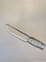 Full view of the clear pressed glass knife
