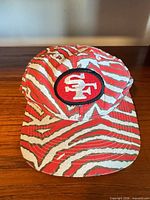 Full view of 49ers cap showing zebra pattern and bill