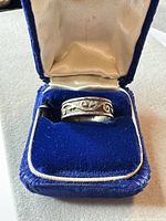 Ring in presentation box showing overall design and tarnish