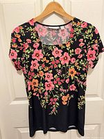 Front view of Susan Graver black floral short sleeve top