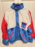Front view of Aviat Sportif blue red white windbreaker on hanger