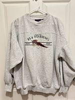 Front view of heather gray sweatshirt showing embroidered Classic Fly Fishing design