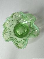 Top view showing entire green pressed glass bowl with ornate pattern