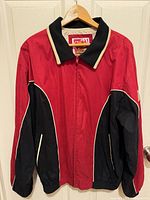 Front view of red and black 49ers jacket showing zip front, contrast panels and piping.
