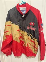 Front view of 49ers windbreaker on hanger