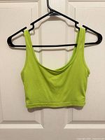 Front view of lime green crop tank top on hanger