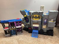 Overall view of both playsets side by side on carpet