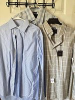 Front view of three shirts on hangers showing patterns and overall condition