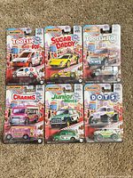 Front view of all six sealed Matchbox Candy series cars on cards