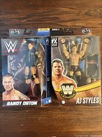 Front view of both sealed figure boxes: Randy Orton and AJ Styles