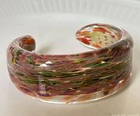 Top angle of Murano glass cuff showing exterior swirl pattern