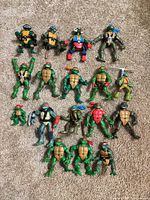 All sixteen TMNT figures laid out on carpet
