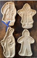 Front view of all four stoneware molds showing designs and shapes