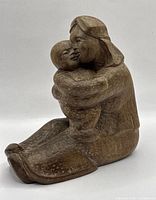 Front left view of carved wood mother and child sculpture