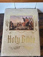 Front cover showing artwork, gold-foil title, shrink wrap