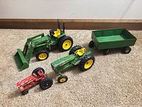 All four farm toys arranged on carpet