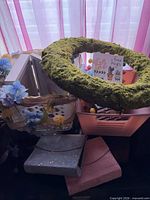 Assorted items together showing moss wreath, floral basket, storage boxes, albums