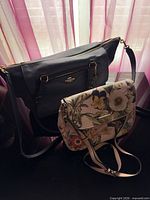Coach navy leather bag front with zip pocket and strap, Dana Buchman floral bag front
