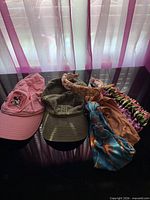 Front view showing both caps, padded floral headband and two ruched headwraps