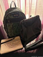 Group shot showing all three bags: mini backpack, crossbody, wristlet