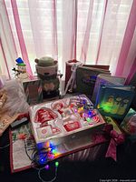 Group shot of entire lot showing lights, snowman, jar, ornaments, books, frames and plush gnome
