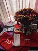 Group shot of all items: wreath in Mickey tin, five stockings, two character washcloths, two Santa towels