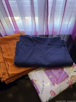 All three tablecloths together showing colors and textures