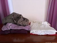 Stack of tops on dresser showing colour range