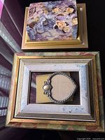 Stacked view of floral photo album on top of two frame fronts