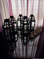 six black metal glass lanterns, six tealights with gold tree inserts
