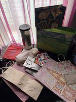overview of assorted gift bags, tissue paper container and tags
