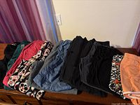 All folded bottoms laid out showing variety of colours and fabrics