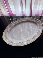 Top view of Noritake Shelburne oval platter showing gold floral rim and handles