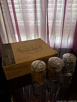 Pampered Chef boxed stoneware pan with three Ball jars displayed