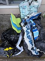 Deflated RAPID tube, black vinyl section, three foam noodles, shark print tote bag