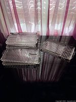 Stack of six ribbed pressed glass trays