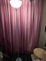 Full view of floor lamp lighting, showing height, pole, base, shade